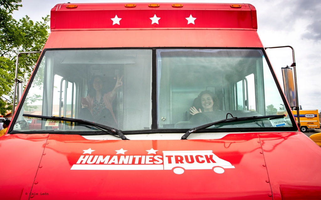 Two women sit in the front of the Humanities Truck